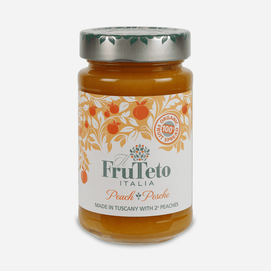 Ein Glas mit Bio-Fruchtaufstrich Pfirsich, verziert mit elegantem Etikett, das Pfirsich-Illustrationen und den Text "100% Bio" zeigt.